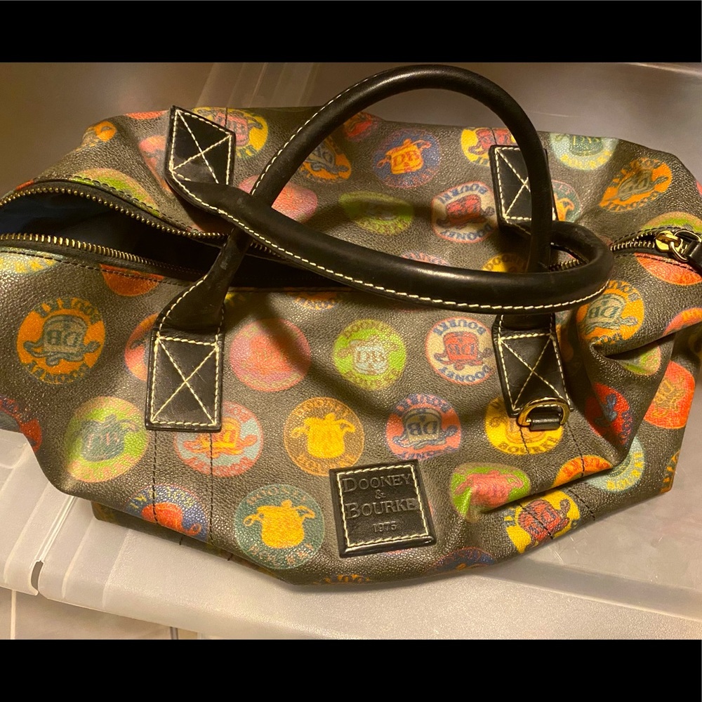 Vintage Dooney and Bourke handbag. Black with multicolor emblems.